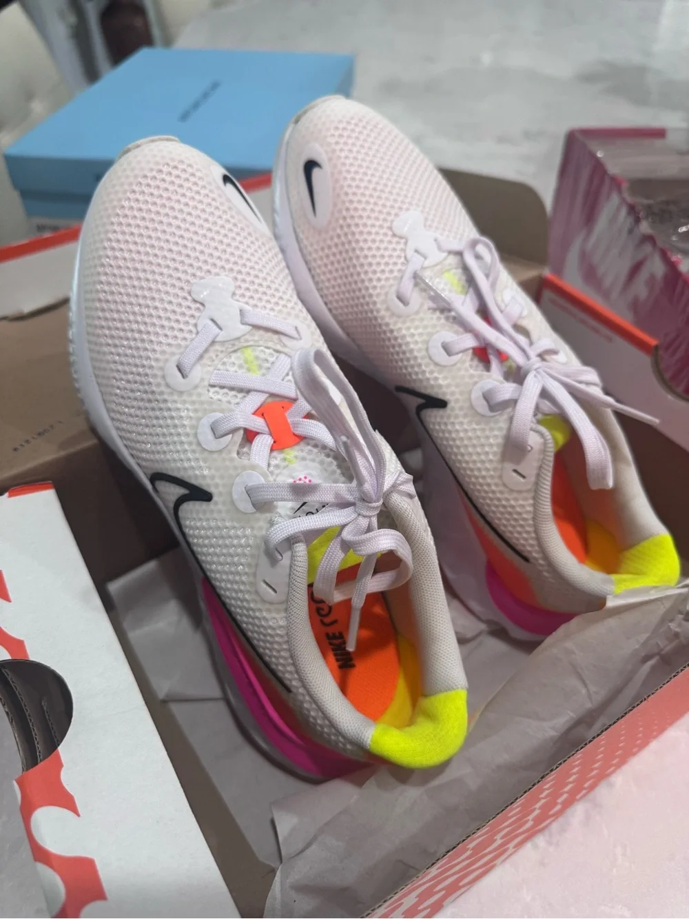Nike White Running Shoe with Pink and Orange Accents